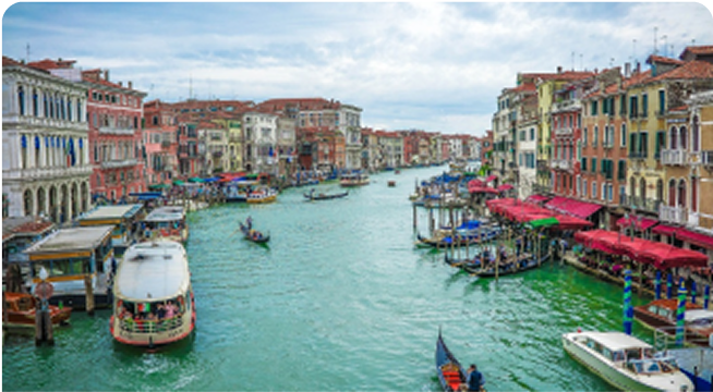 Venice canal with boats and colorful buildings